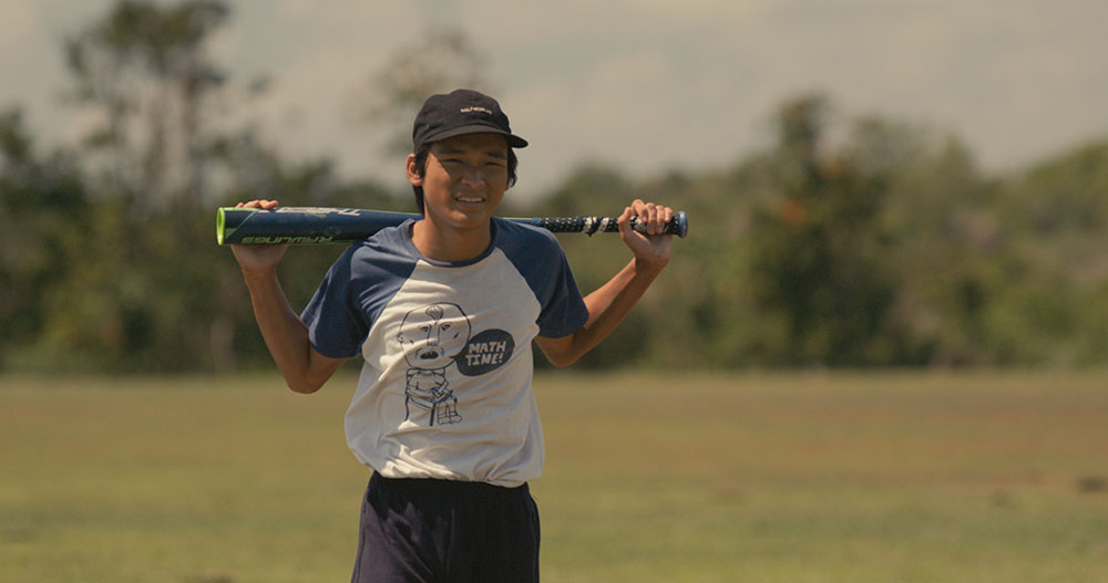 Young boy holding a baseball bat in Cinemalaya film, The Baseball Player