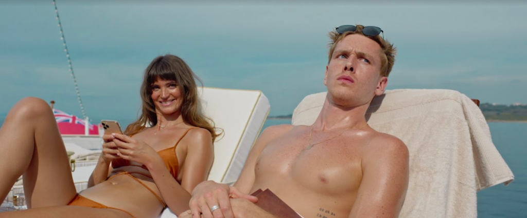 Young rich couple sunbathing in Triangle of Sadness movie