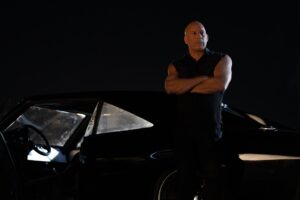 Vin Diesel leaning on a car for Fast X