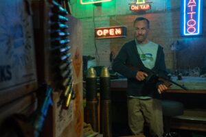 Hutch Mansell holding a gun in Nobody 2