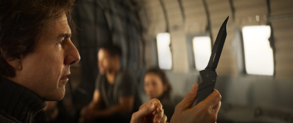 Tom Cruise with a knife in Mission: Impossible - The Final Reckoning now showing in cinemas
