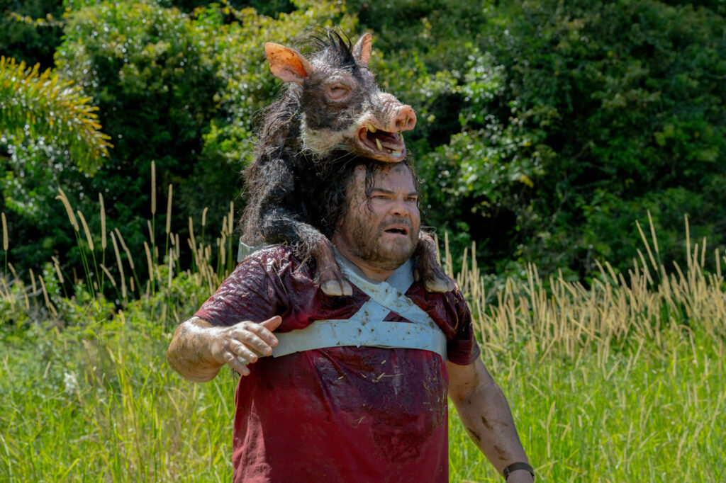 Jack Black with pig on his shoulders in Anaconda