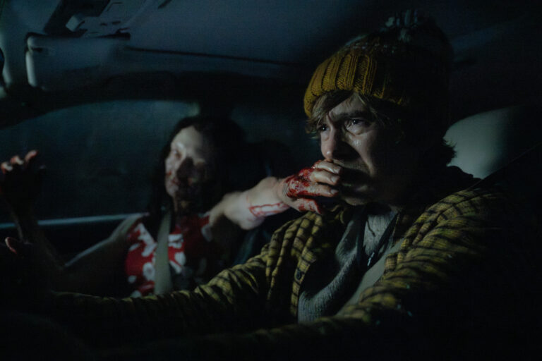 Man behind the wheel with zombie Resident Evil